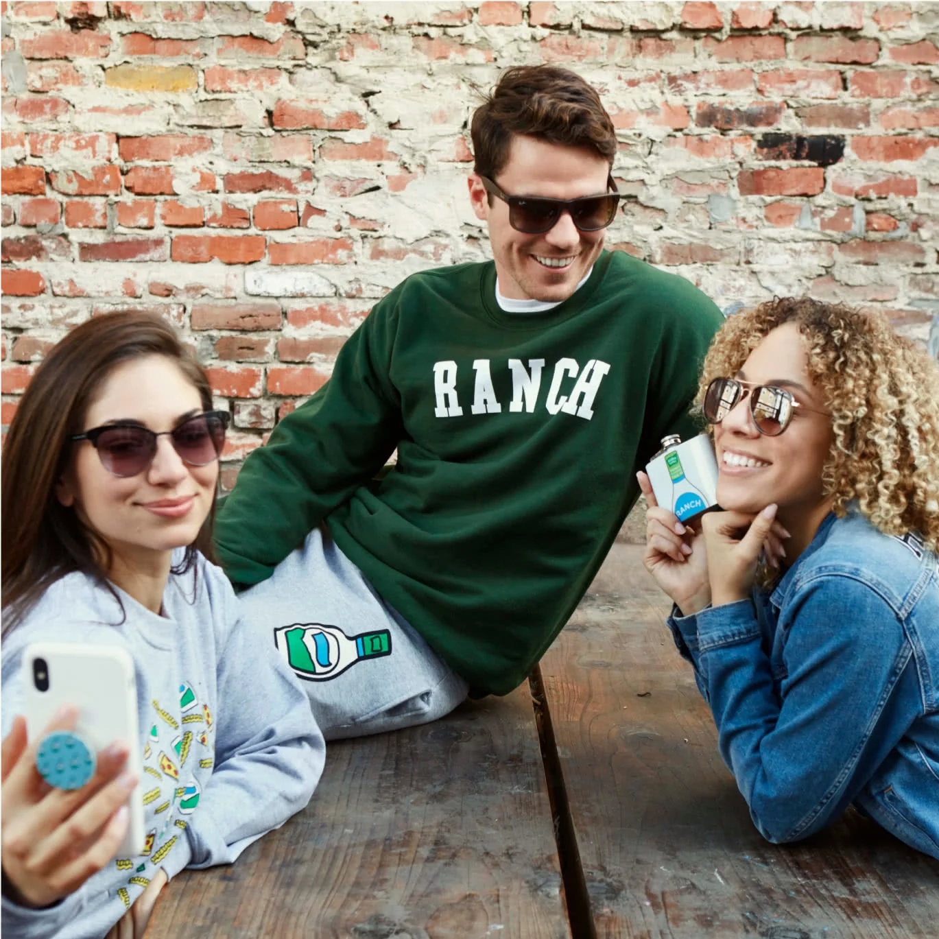 people with Ranch Shop items in front of a brick wall
